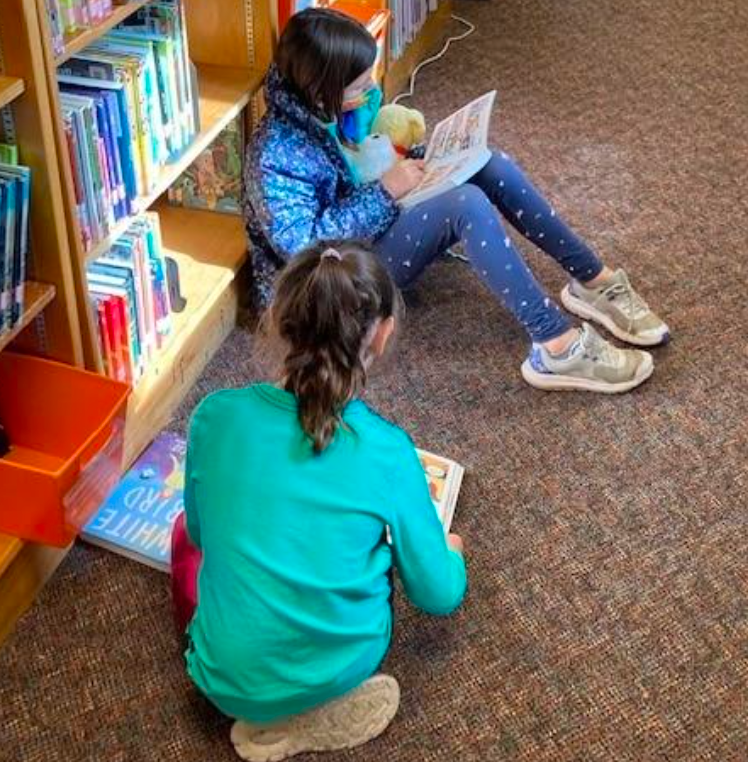 Students reading on the floor in the library