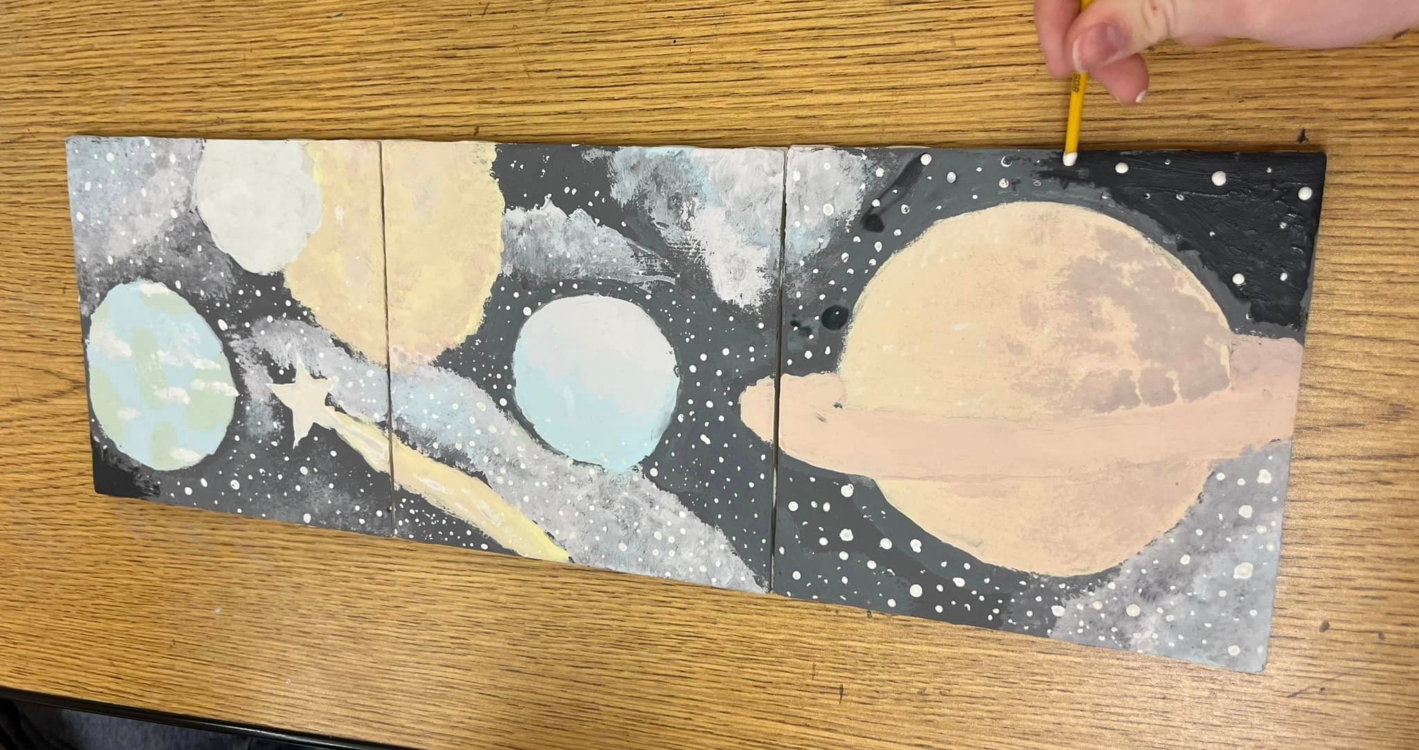 Planets and stars painted with glaze.